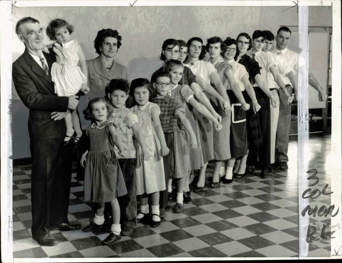 Families-large - Responding to plea of the Mothers' March on Polio, the nation's largest family turns out en masse for anti-polio vaccine injections. Baring their arms are Mr. and Mrs. Elmer de Golier of Brocton, New York, and their 20 children. Mr. de Golier holds Janeen, three, and his wife stands next to him. Children are (left to right) Valerie, five; Reed, six; Charlene, seven; Keith, 10; Sharon, 11; Sheila, 13; Rozella, 16; Ardys, 17; Theora, 20; Gloria Lee, 24; Joyce, 28, Carl, 14; Warren, 19 and Dexter, 27. Children not present are Wanda, 19; Dennis, 21; Joan, 23; Beverly, 25, and Gordon, 26.