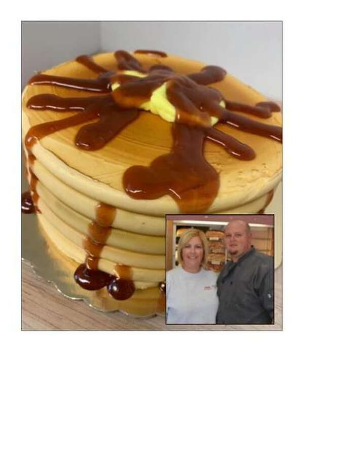 These pancakes are actually a cake created by Amy and Ben Hollis, seen in the insert, of Duke’s Bakery in Alton. While known for their doughnuts and cookies, a large portion of the bakery’s business are custom-ordered cakes.