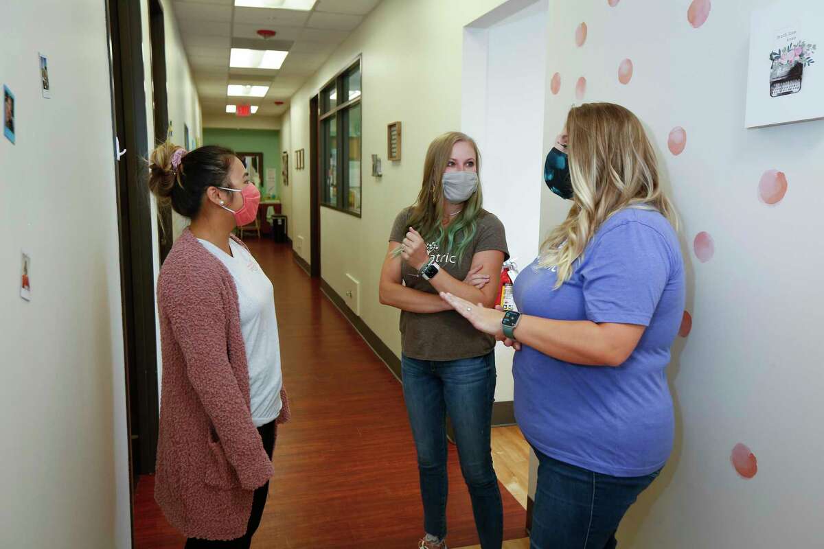 Stephanie Hocson (left) chats with Michelle Mitcham and Amber Humphrey, co-CEOs of Open Door Pediatric Wednesday, Aug. 26, 2020, in Houston.