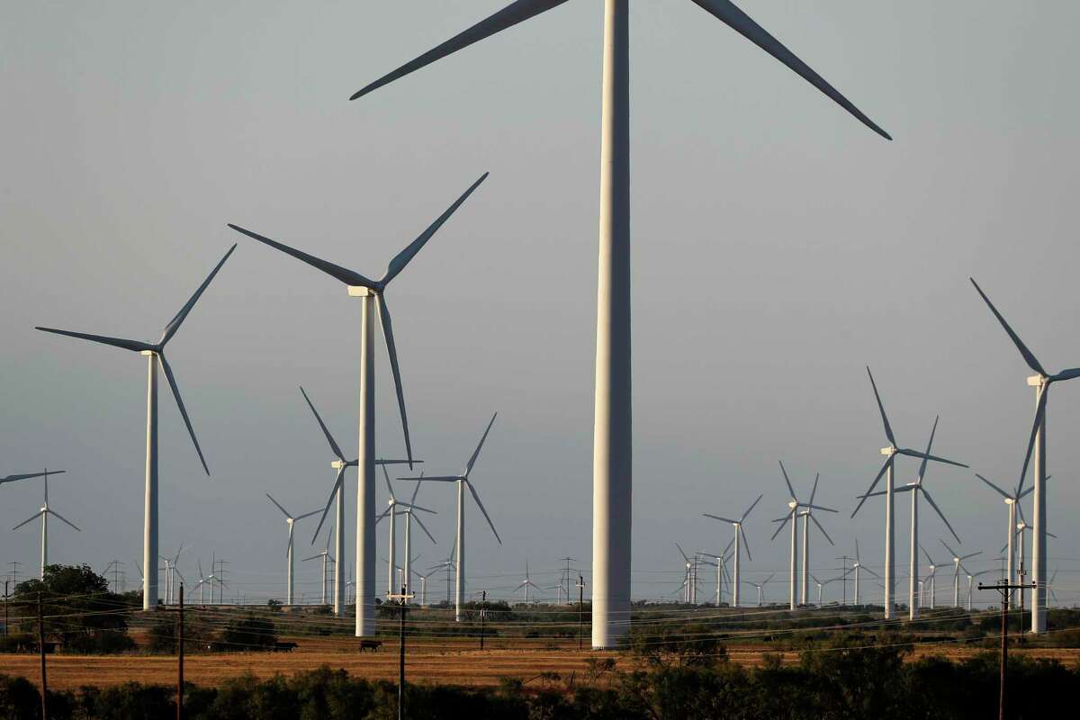 Wind turbines are seen on a rural road off of Interstate 20, Wednesday, July 29, 2020, near Sweetwater, Texas.