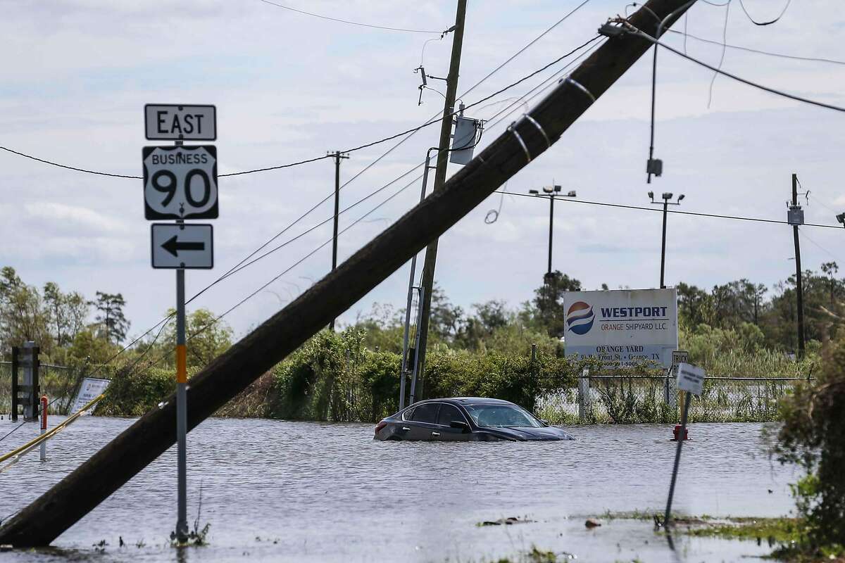 A car submerged in a flood on Pier Rd after Hurricane Laura hit the area overnight in Orange on Thursday, August 27, 2020. After Hurricane Laura made landfall on the Texas Coast last week, the flow of the Neches River slowed and then reversed entirely. (Lola Gomez/Austin American-Statemen/TNS)