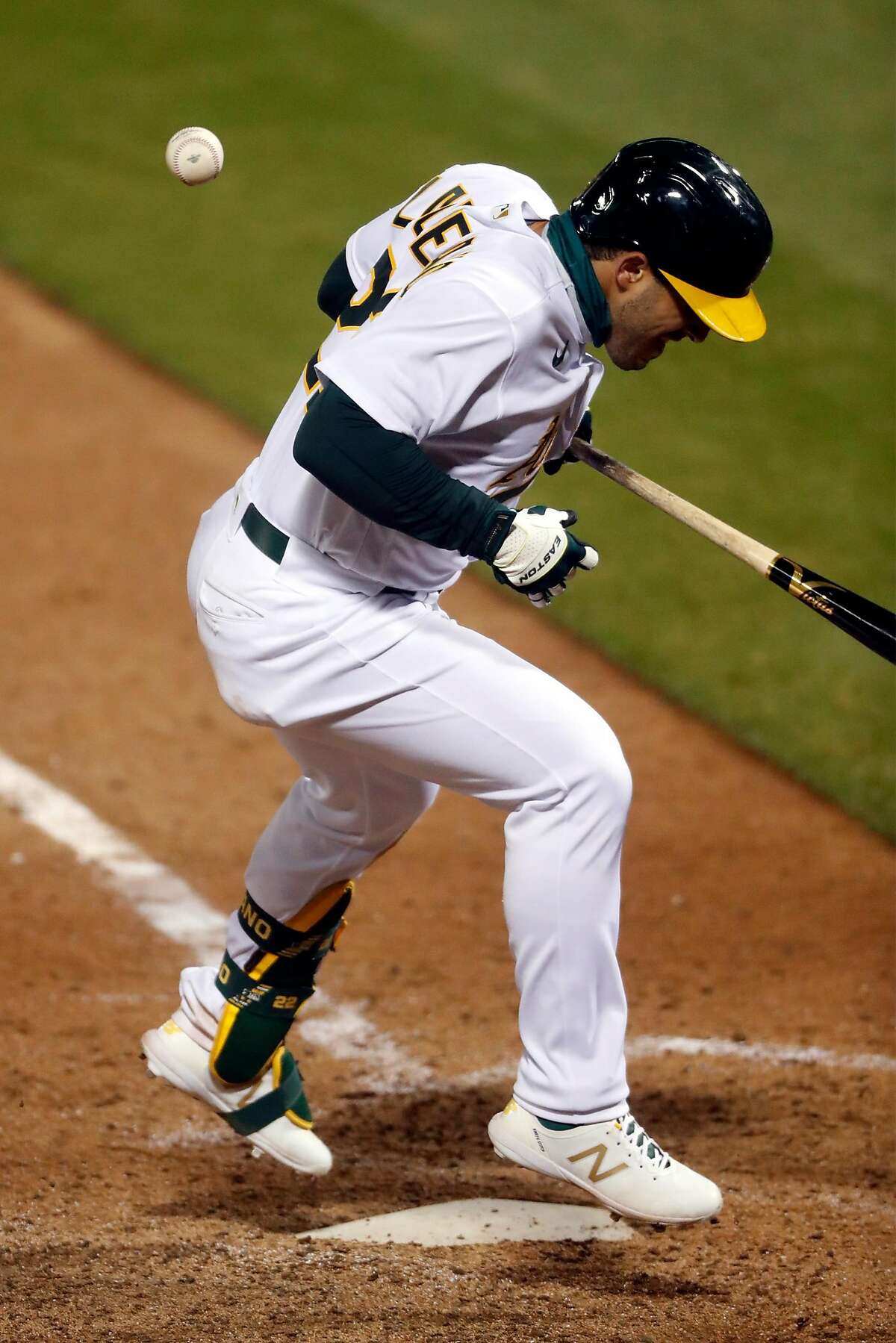 Oakland Athletics' Ramon Laureano is hit by a pitch in 10th inning of 7-3 win over Los Angeles Angels during MLB game at Oakland Coliseum in Oakland, Calif., on Friday, July 24, 2020.