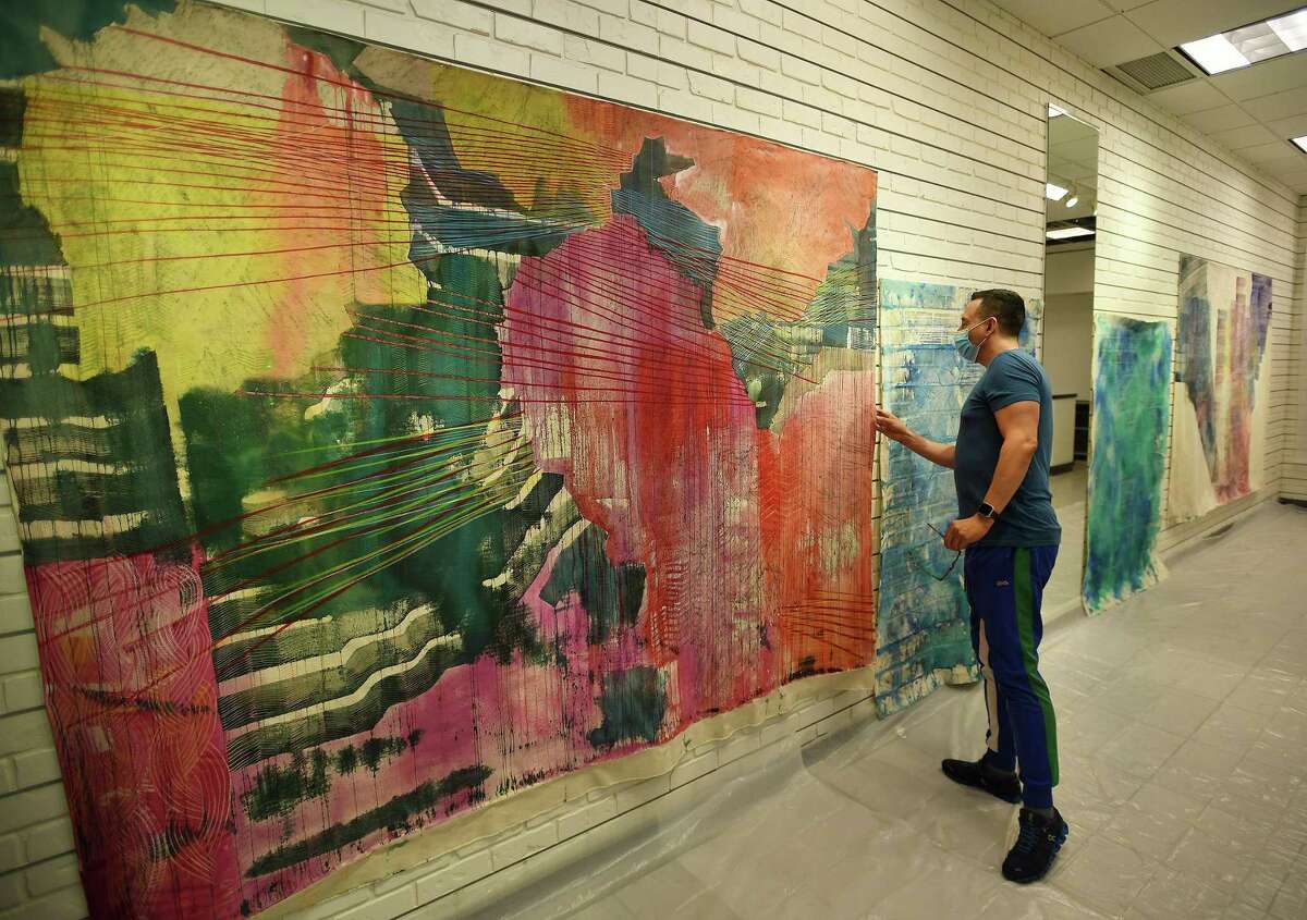 Clementina Arts Foundation founder Fernando Luis Alvarez gets his first look at the work of artist-in-residence Alyse Rosner, of Westport, at the Sprouting Spaces studio at the Stamford Town Center mall in Stamford, Conn. on Monday, Aug. 31, 2020.