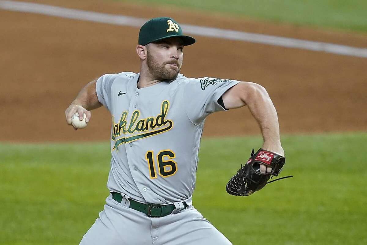 Oakland Athletics relief pitcher Liam Hendriks throws to a Texas Rangers batter during the ninth inning of a baseball game in Arlington, Texas, Wednesday Aug. 26, 2020. (AP Photo/Tony Gutierrez)