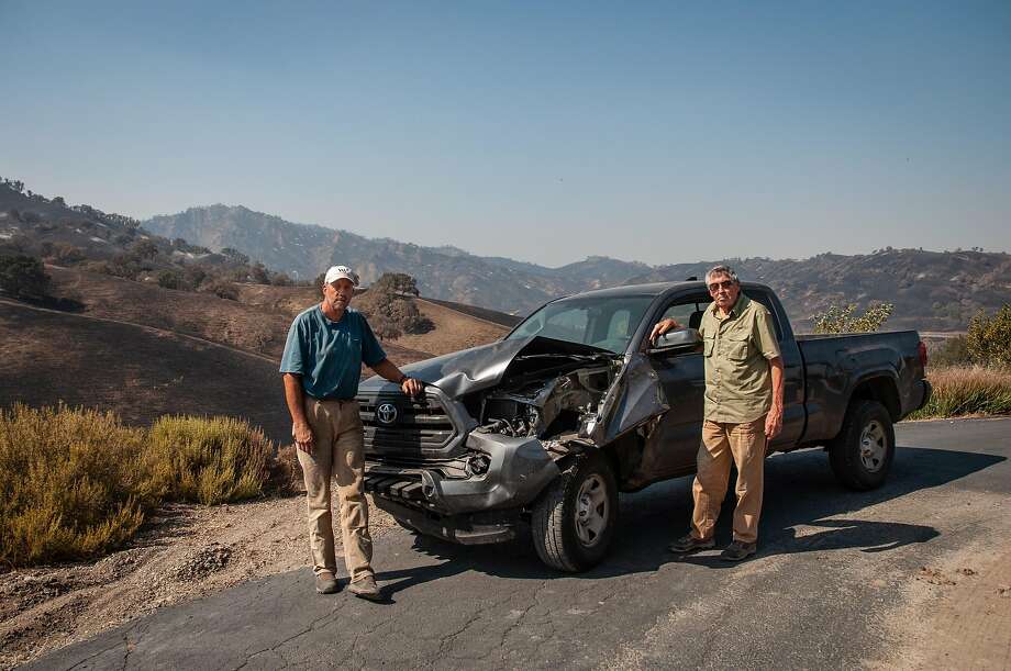 Kurt and Jerome Balasek pose with their car that was damaged by a horse during the LNU Complex Fire, as seen in Vacaville, Calif. on August 27, 2020. Photo: Annika Hammerschlag / Special To The Chronicle
