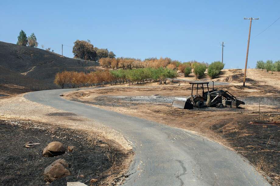The remnants of a tractor scorched by the LNU Complex Fire sits on Kurt Balasek's property in Vacaville, Calif. on August 27, 2020. Balasek called  911 when the LNU Complex Fire approached his home on Quail Canyon Road in Vacaville, however the firefighters never came. Photo: Annika Hammerschlag / Special To The Chronicle