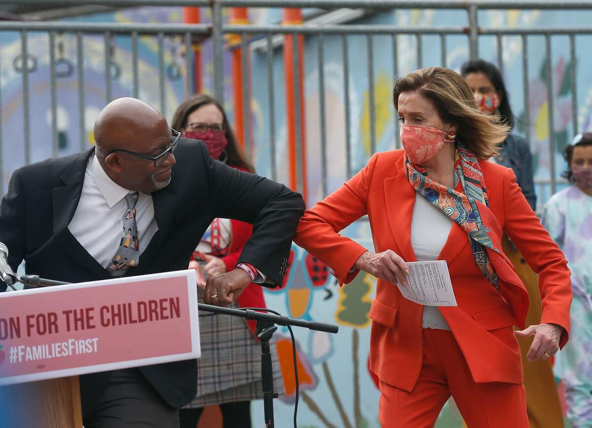 House Speaker Nancy Pelosi elbow bumps with SF schools superintendent Vincent Matthews after he introduced her during a news conference at Mission Education Center Elementary School in San Francisco, Calif. on Wednesday, Sept. 2, 2020. Rep. Pelosi was captured in a video image having her hair washed and styled indoors at a Marina District salon despite local ordinances restricting the activity during the coronavirus pandemic shutdown.