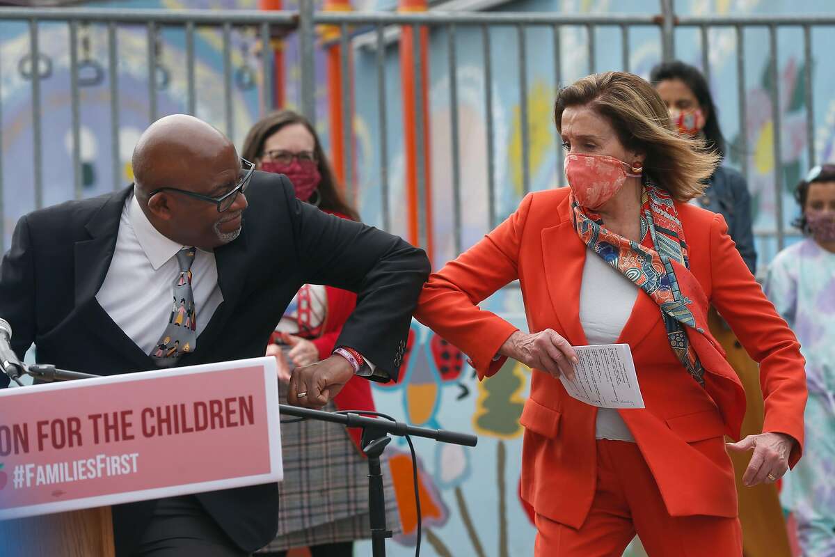 House Speaker Nancy Pelosi bumps elbows with S.F. schools Superintendent Vincent Matthews after he introduced her during a news conference.
