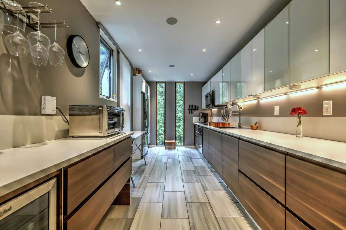 In the kitchen there is radiant heat flooring, plenty of counter space and cabinets, and under cabinet lighting. "This home offers gracious and comfortable living and plenty of space to entertain family and friends inside and out," the listing agent said. Stone steps lined with attractive landscaping lead to the front door. Inside the 2,550-square-foot house there are seven rooms and an open floor plan. "You need to tour this home to appreciate the undeniable attention to detail within every inch," the agent said. The home features high ceilings, new wood flooring on main level, and oversized custom windows and doors throughout.