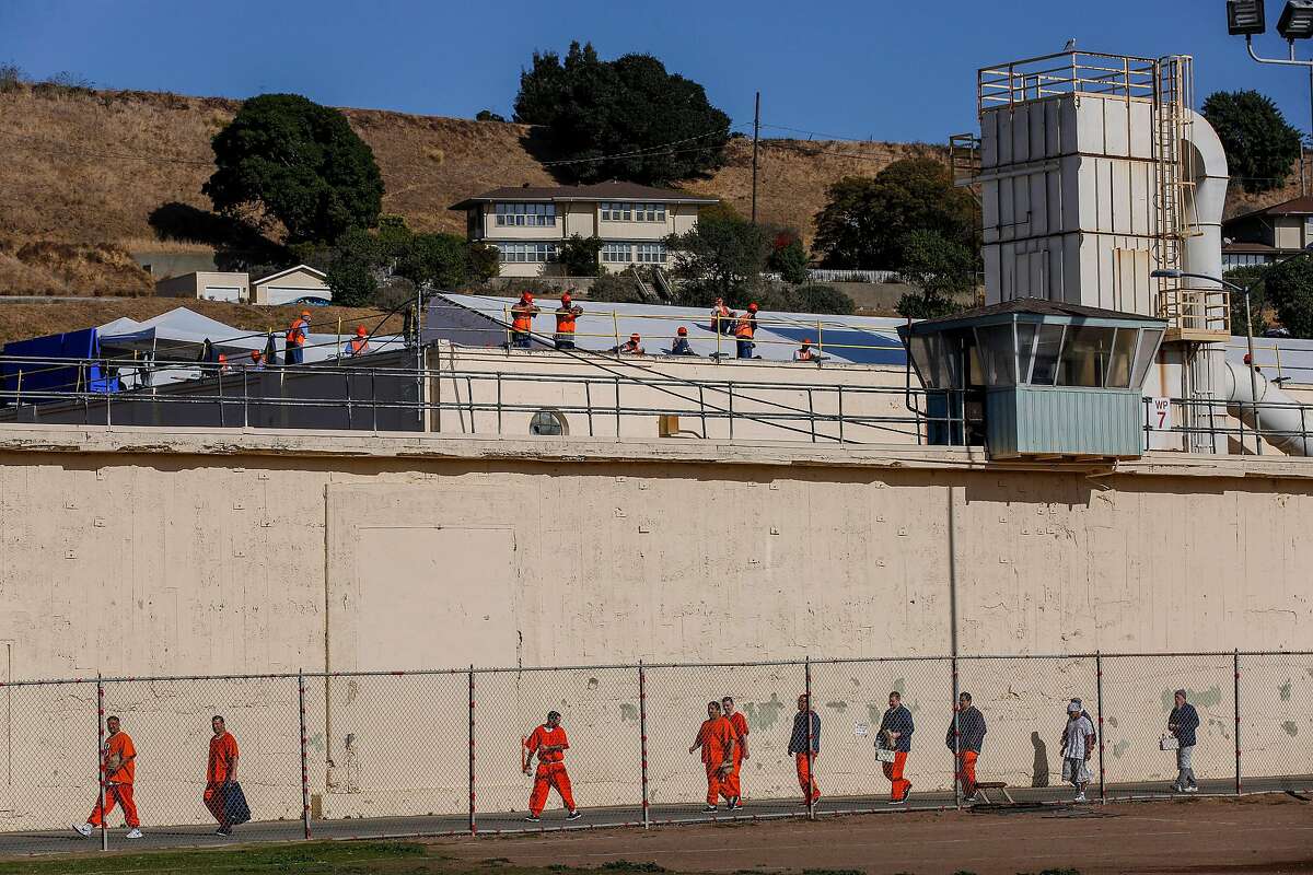 Construction workers watch the prisoners at San Quentin State Prison on Friday, Nov. 22, 2019, in San Quentin, Calif. The prison’s 1,000