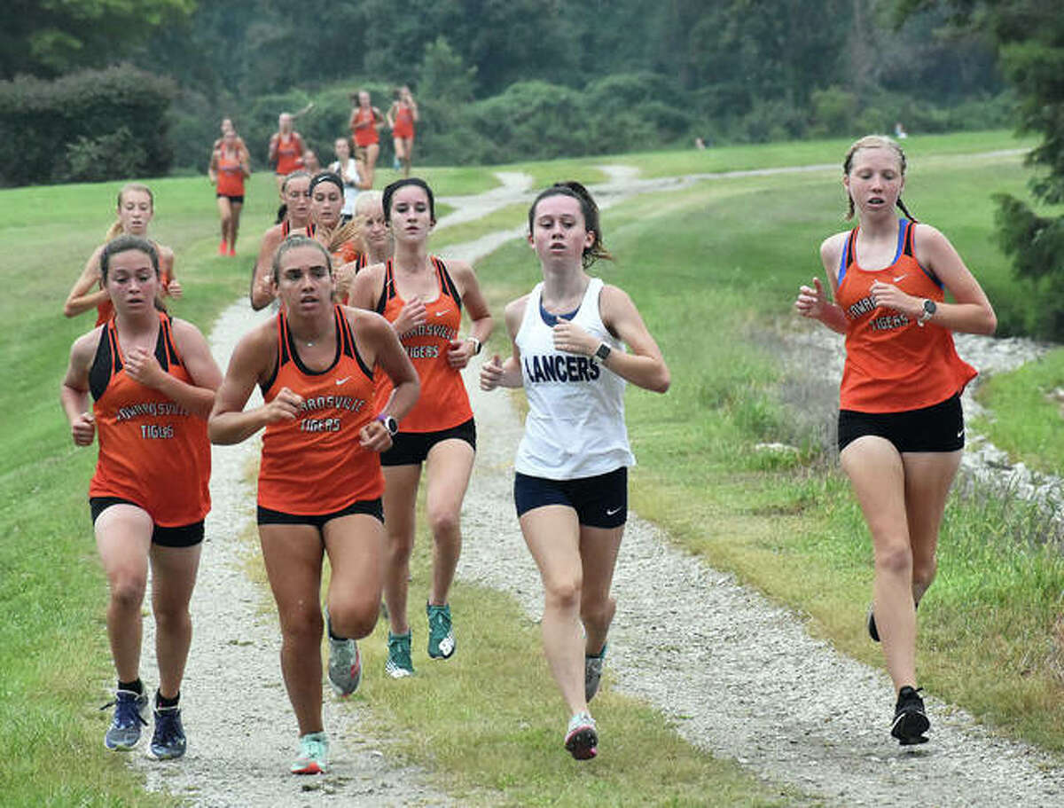Edwardsville’s Olivia Coll, far left, won the girls race of the Belleville East Dual on Wednesday at Clinton Hills Conservation Park in Swansea.