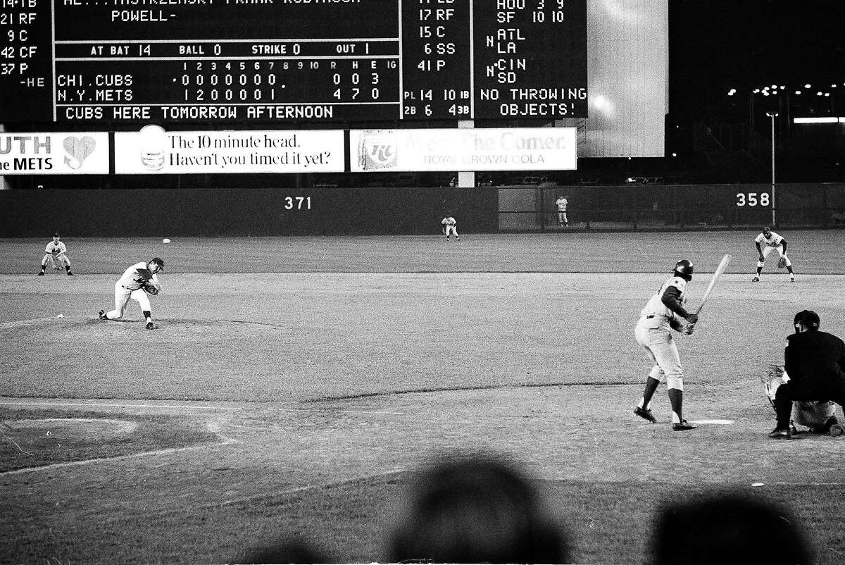 FILE - In this July 10, 1969, file photo, New York Mets pitcher Tom Seaver, left, throws to Chicago Cubs batter Ron Santo, who flied out to center field during the eighth inning of a baseball game in New York. Seaver's bid for perfect game was spoiled in ninth inning, but the Mets won 4-0. Seaver, the galvanizing leader of the Miracle Mets 1969 championship team and a pitcher who personified the rise of expansion teams during an era of radical change for baseball, has died. He was 75. The Hall of Fame said Wednesday night, Sept. 2, 2020, that Seaver died Aug. 31 from complications of Lewy body dementia and COVID-19. (AP Photo, File)