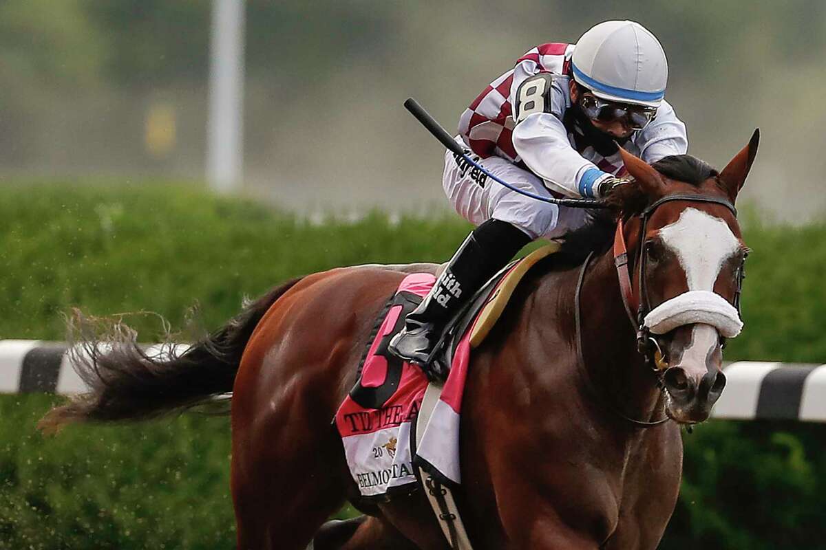 FILE - In this June 20, 2020, file photo, Tiz the Law (8), with jockey Manny Franco up, approaches the finish line on his way to win the152nd running of the Belmont Stakes horse race in Elmont, N.Y.  (AP Photo/Seth Wenig, File)