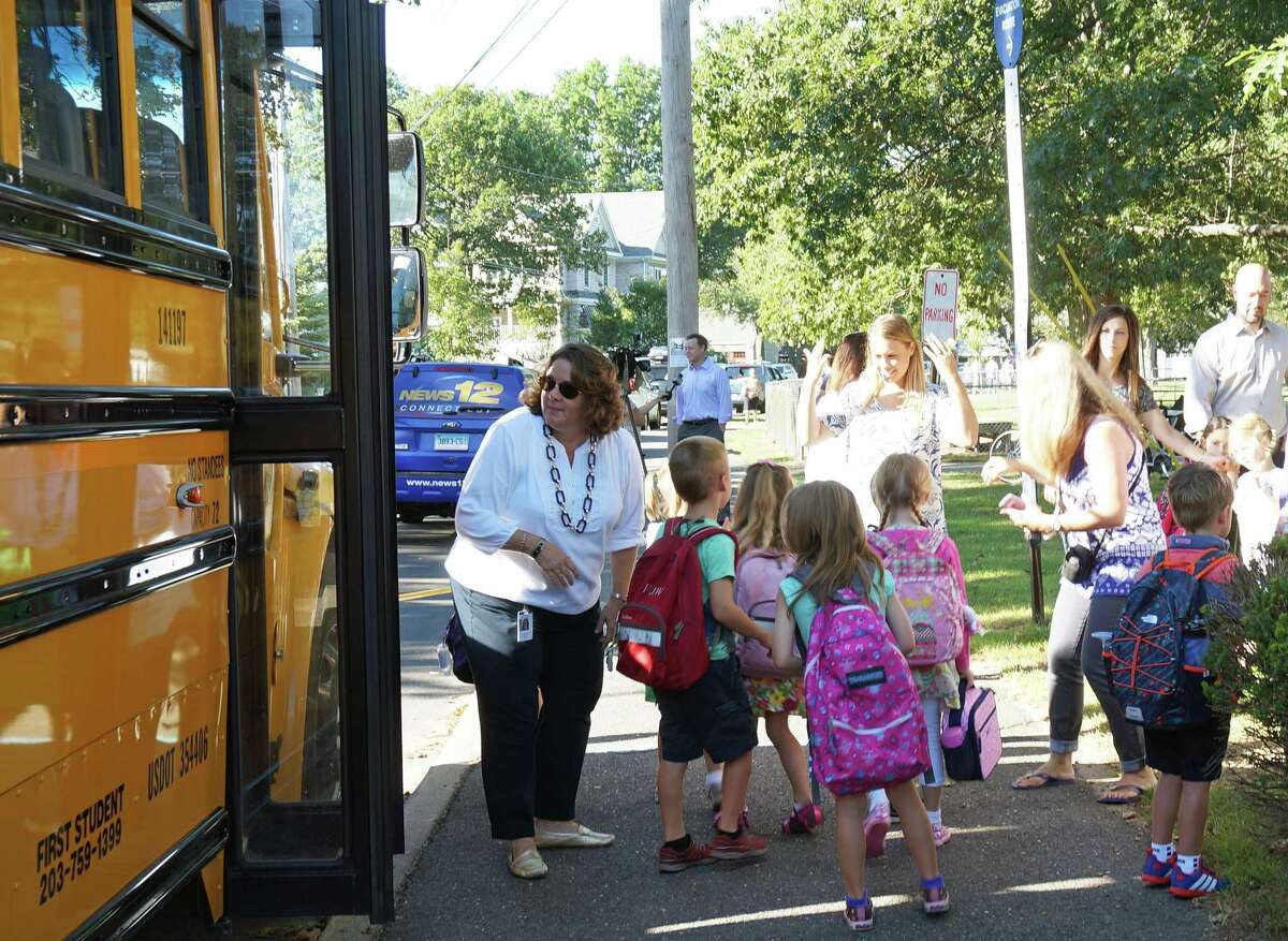 School buses arrive at Sherman School for the first day of the 2019 school year.
