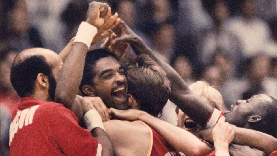 Ralph Sampson is mobbed by his Rockets teammates after his Game 5 buzzer-beating shot to beat the Lakers and send his team to the 1986 NBA Finals.