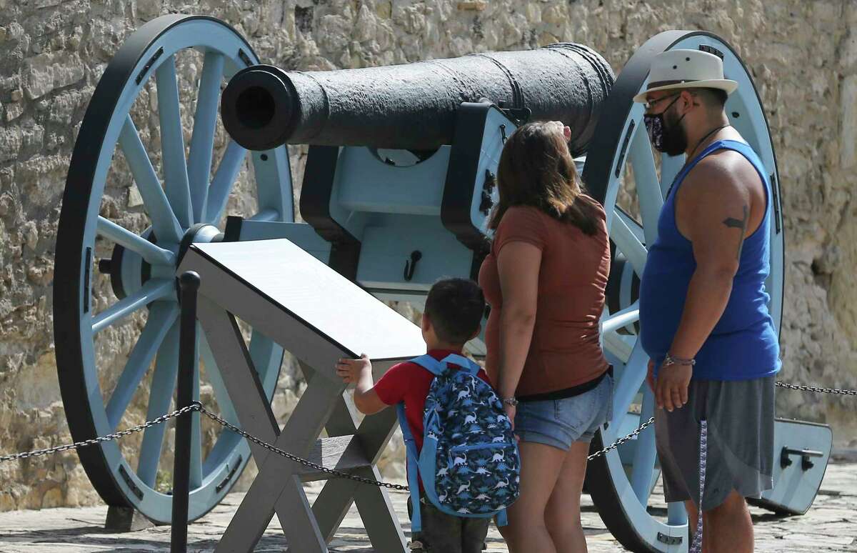 Visitors stop in front of a cannon as the Alamo re-opens its iconic mission-era church to the public on Thursday, Sept. 3, 2020. New research at the Alamo reveals the long-lost “18-pounder” cannon fired at the start of the 13-day siege in 1836 was actually a Swedish 9-pounder cannon that was altered to fire larger ammunition. That means the 16-pounder cannon in this photo was the largest cannon in use during the Battle of the Alamo.