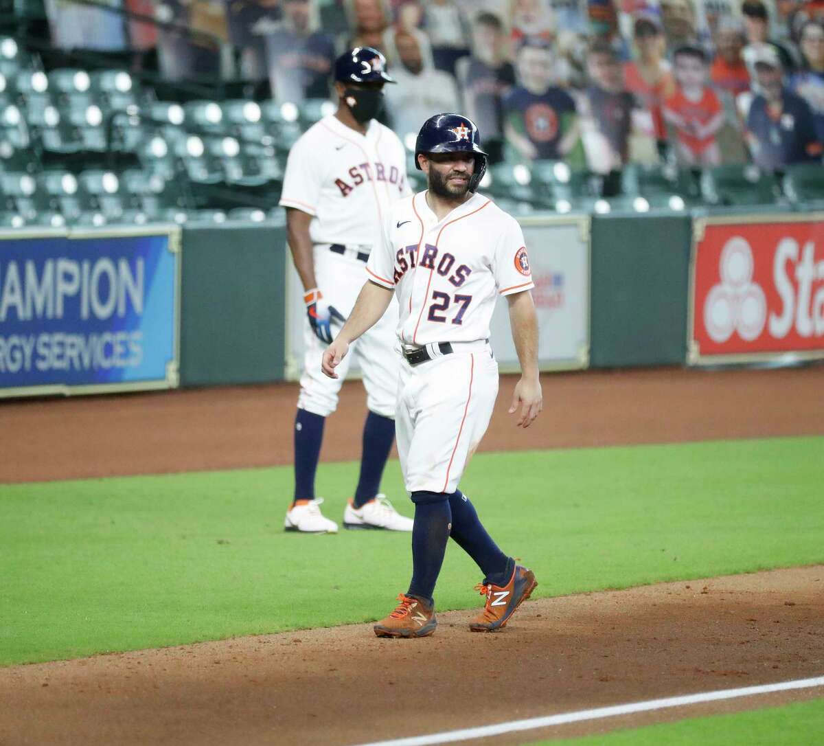 Houston Astros Jose Altuve (27) grimaces at third base after he slid into third as Yuli Gurriel lined out during the first inning of an MLB baseball game at Minute Maid Park, Thursday, September 3, 2020, in Houston.