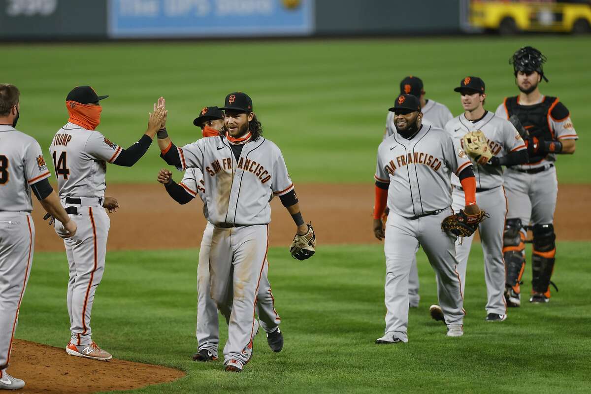 DENVER, CO - SEPTEMBER 01: Brandon Crawford #35 of the San Francisco Giants leads the team off the field as the team celebrates their 23-5 win against the Colorado Rockies at Coors Field on September 1, 2020 in Denver, Colorado. (Photo by Justin Edmonds/Getty Images)