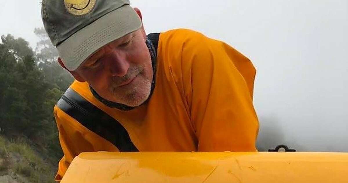 David Alexander, a school administrator, surveys the bite marks on the front of his kayak after a great white shark took the front of the boat in its mouth