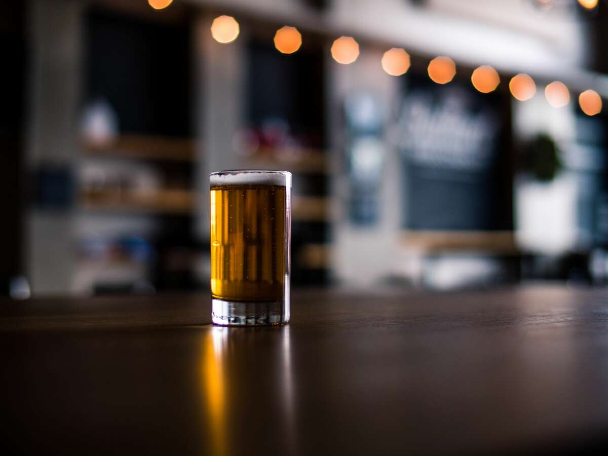 File image of a glass of beer atop a bar.