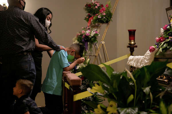 Alex and her husband, Roberto Vasquez Jr., comfort their son, Fabian Vasquez, 8, as he kneels in front of his grandmother's casket during the July 31 visitation at Trinity Mortuary in Del Rio.