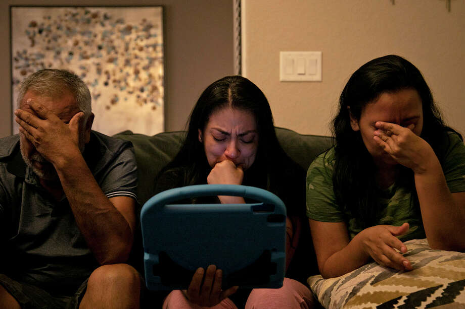 Vanessa Dyer, center; her sister, Alex Vasquez, and their father, Enrique Rangel, are brought to tears as their brother Andy Rangel tells Nora Rangel during a video call that if she was tired, it was OK to go. Photo: Lisa Krantz, Staff Photographer / San Antonio Express-News