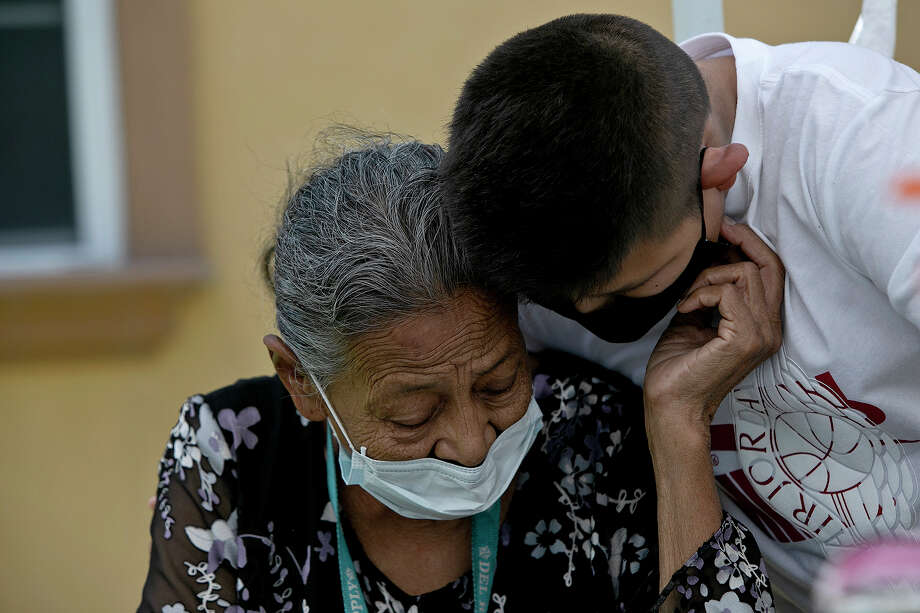 Felicitas Rangel, Enrique's mother and Nora's mother-in-law, shares a moment with Miguel Hernandez during lunch Alex's home after Nora's funeral. Nora and Enrique had been married nearly 44 years. Photo: Lisa Krantz, Staff Photographer / San Antonio Express-News