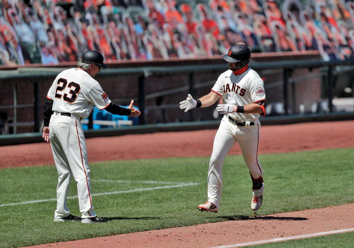 Evan Longoria (10) gestures toward third base coach Ron Wotus after hittinga solo homerun in the sixth inning as the San Francisco Giants played the Texas Rangers at the Oracle Park in San Francisco, Calif., on Sunday, August 2, 2020.