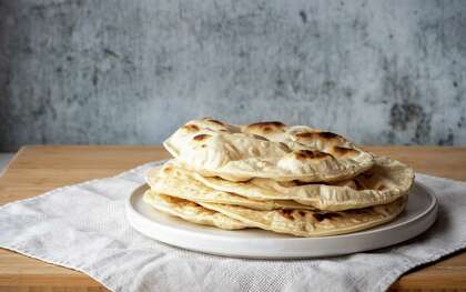 A tortilla press is great for pressing out dough for naan, pitas and other flatbreads.