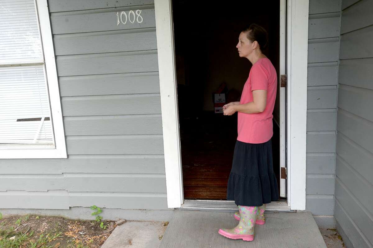 Rachael Royer stands in the doorway of her rental property as insurance adjusters look inside to assess damage from a fallen tree in Orange a week after the area was hit with some of the most severe damage in Southeast Texas by Hurricane Laura. Royer says several of her rental properties in the area sustained damage. Photo taken Thursday, September 3, 2020 Kim Brent/The Enterprise