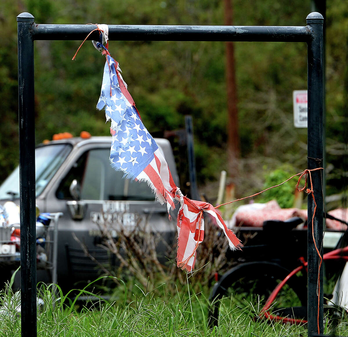 A shredded flag hangs outside a home in Orange a week after the area was hit with some of the most severe damage in Southeast Texas by Hurricane Laura. Photo taken Thursday, September 3, 2020 Kim Brent/The Enterprise