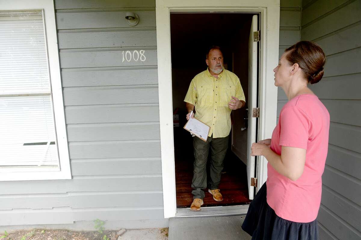 Rachael Royer talks with insurance adjuster Johnny Hancock as he surveys damage done to one of her rental properties in Orange a week after the area was hit with some of the most severe damage in Southeast Texas by Hurricane Laura. Royer owns several rental properties, many of which sustained damage. She says this property had also been vandalized as she discovered a broken window and graffiti sprayed on a wall inside. Photo taken Thursday, September 3, 2020 Kim Brent/The Enterprise