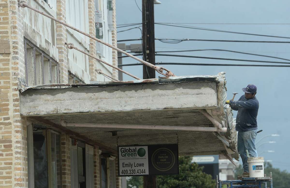 A worker removes damage from the awning of a historic building on N. 5th in Orange a week after the area was hit with some of the most severe damage in Southeast Texas by Hurricane Laura. Photo taken Thursday, September 3, 2020 Kim Brent/The Enterprise