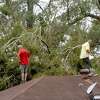 Insurance adjusters Donnie Hallman (left) and Johnny Hancock survey the roof of a home in Orange where a tree crashed above the garage as work continues a week after the area was hit with some of the most severe damage in Southeast Texas by Hurricane Laura. Photo taken Thursday, September 3, 2020 Kim Brent/The Enterprise