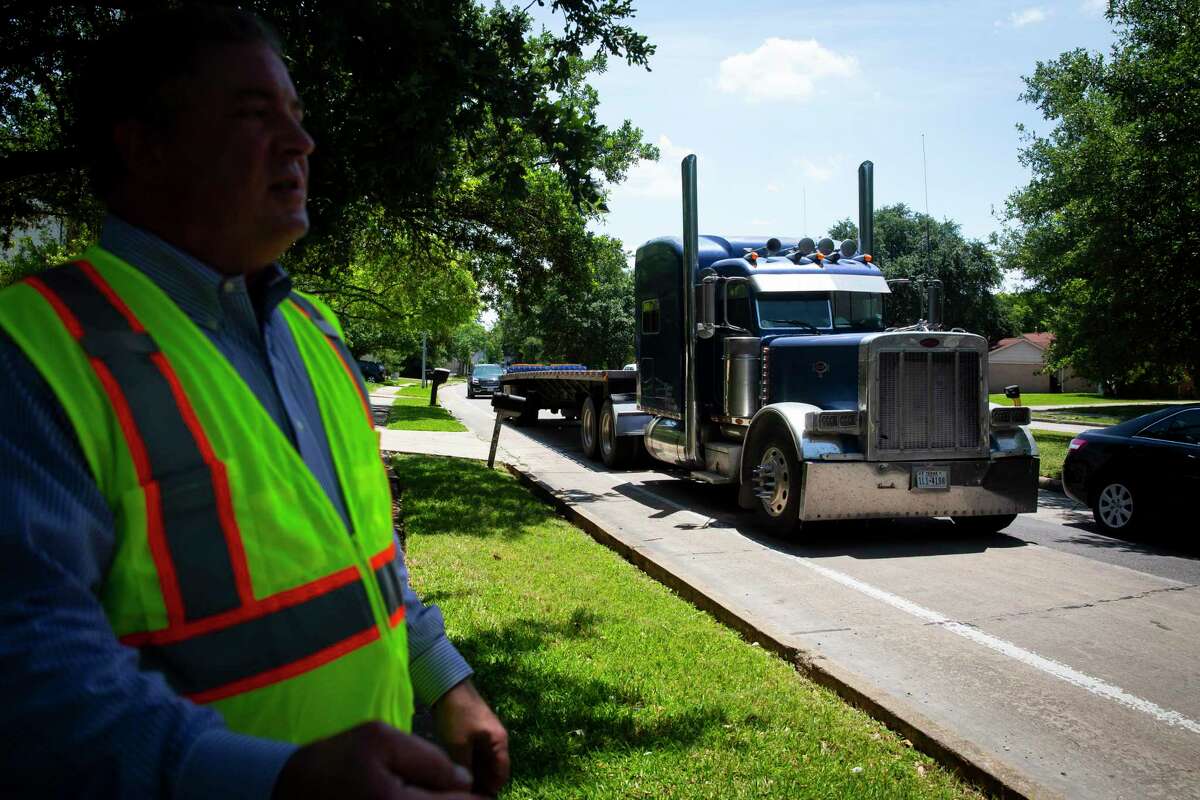 A truck drives along Kirkwood beside Councilman Greg Travis on Monday, May 11, 2020.