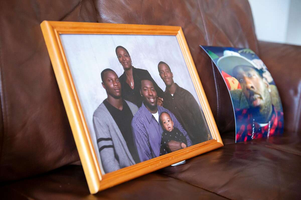 A family portrait of Steven Taylor, his son, two brothers and his mother sits on Addie Kitchen's couch at her home in Vallejo, Calif. on Thursday, September 3, 2020. Kitchen's grandson, Steven Taylor was shot on April 18, 2020 by a San Leandro police officer inside of a Walmart store. Recently the police officer involved in the shooting was charged with voluntary manslaughter for Taylors death.