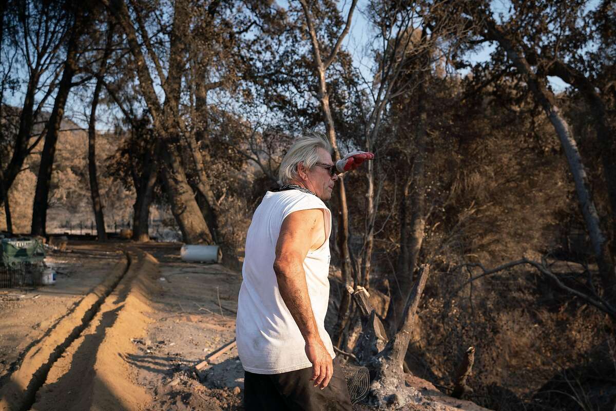 Jim Campbell, 68, walks through his property that was destroyed by the Hennessey Fire on Pleasants Valley Road in Vacaville, Calif. on Thursday, Sept. 3, 2020. "None of our animals were hurt and that is a miracle," said Campbell who has lived at the property for over 12 years.