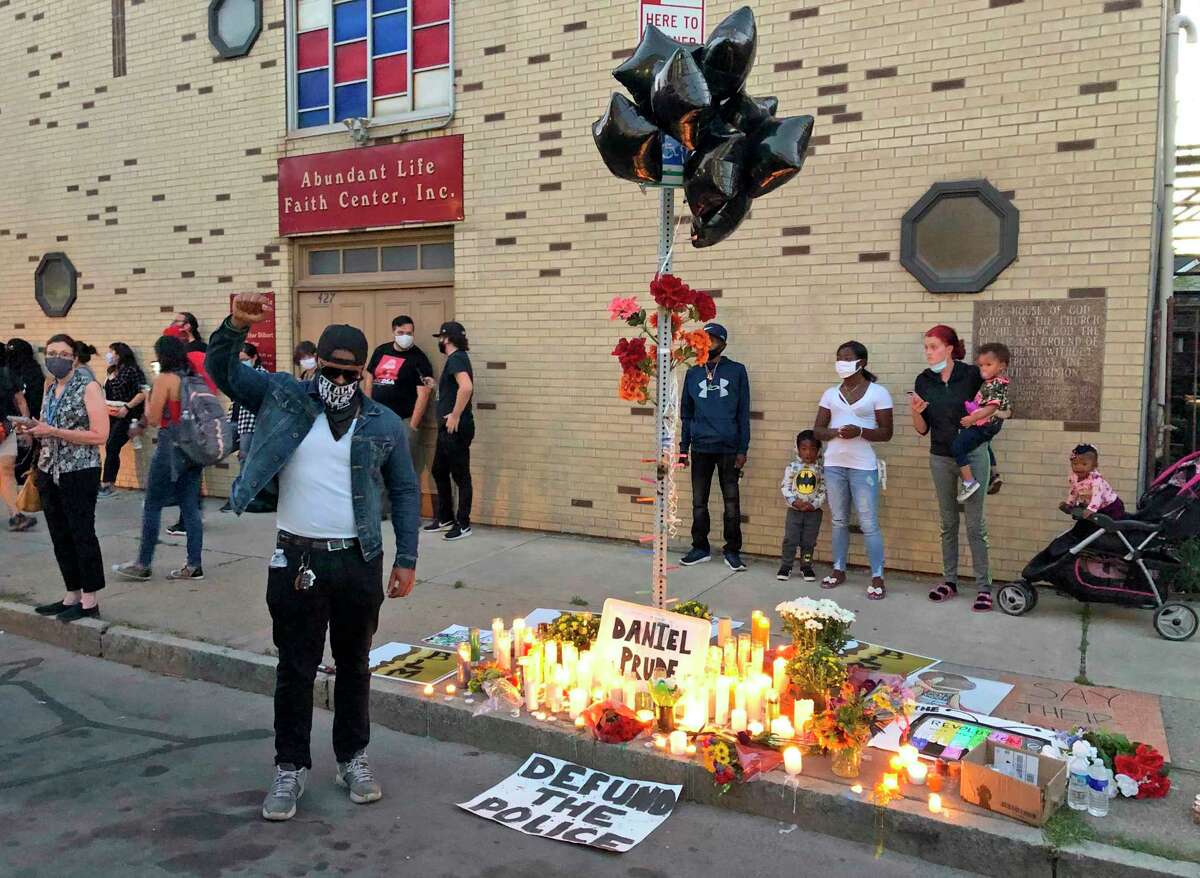 Protesters gather near a memorial for Daniel Prude at the site of his death, Thursday, Sept. 3. 2020 in Rochester, N.Y. Prude, a 41-year-old Black man, died March 30, 2020. His family took him off life support seven days after Rochester police officers encountered him running naked through the street, put a hood over his head to stop him from spitting, then held him down for about two minutes until he stopped breathing. (AP Photo/Ted Shaffrey)