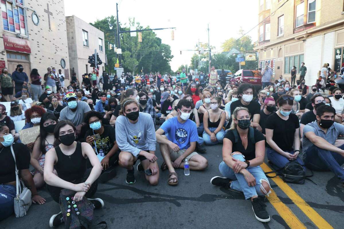 ROCHESTER, NEW YORK - SEPTEMBER 03: Demonstrators stage a sit in at the site where Daniel Prude was arrested after marching from a community gathering on September 03, 2020 in Rochester, New York. Prude died after being arrested on March 23 by Rochester police officers who had placed a "spit hood" over his head and pinned him to the ground while restraining him. Mayor Lovely Warren announced today the suspension of seven officers involved in the arrest. (Photo by Michael M. Santiago/Getty Images)