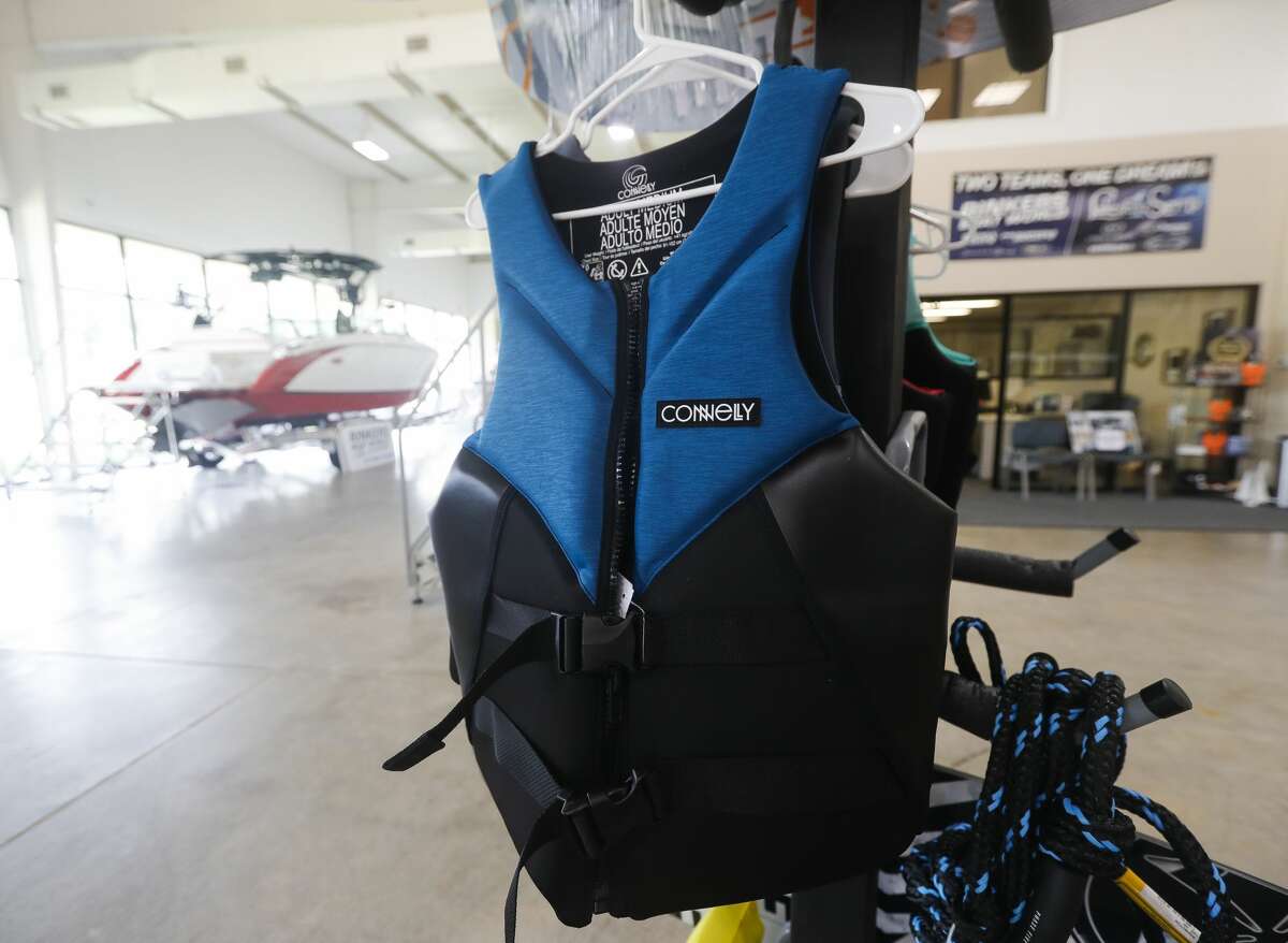Melanie Clement, general manager at Rinkers Boat World at Lakeshore, shows some of the various life jacket options aviable to customers, Thursday, Sept. 3, 2020, in Montgomery. With all of this yearâs drowning victims on Lake Conroe not wearing life jackets to date, Montgomery County law enforcement and vendors continue to urge lake visitors to wear safety vests.