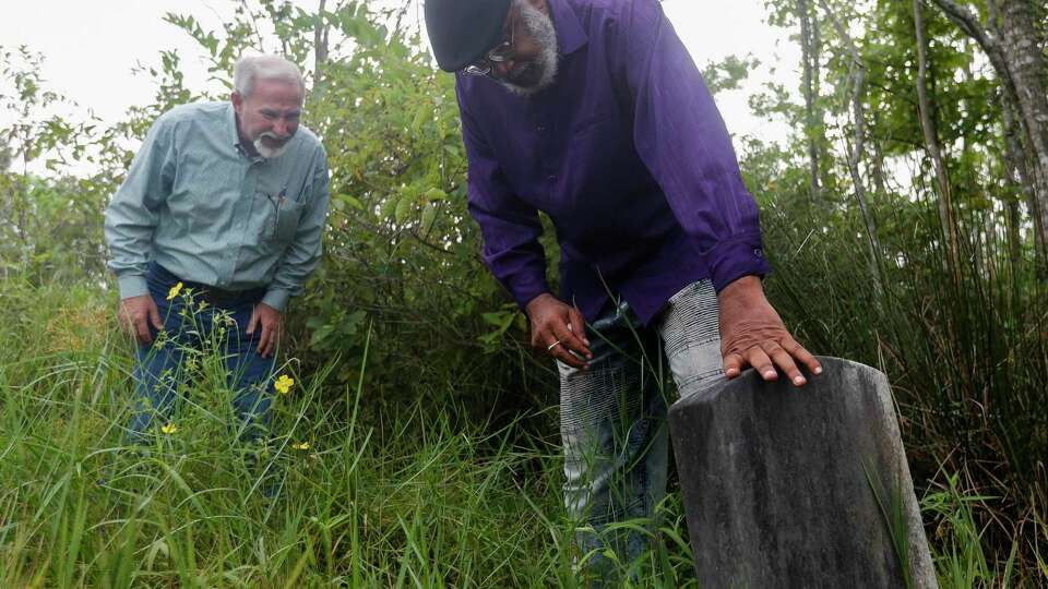 Elikah Easley, chairman of the Tamina Cemetery and Community Development Cooperation, points out the headstone of his grandfather, Romie Hollins Sr., to Montgomery County Precinct 4 Commissioner James Metts during a tour of Sweet Rest Cemetery, Thursday, Sept. 3, 2020, in Tamina. Dating back to the 1870s, the site is the final resting place of 260 former slaves, Native Americans, military veterans and law enforcement officials and original settlers of the Tamina community, a post-Civil War Freedman's settlement.