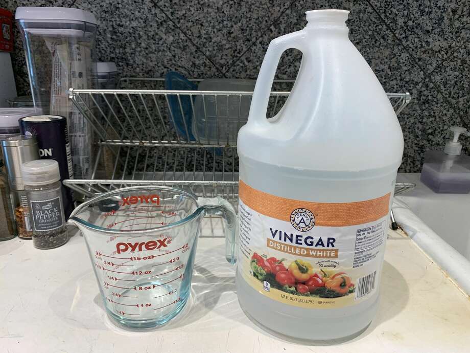To remove rust, soak the cast iron cookware in a 50/50 vinegar solution. Photo: Ryan Craggs