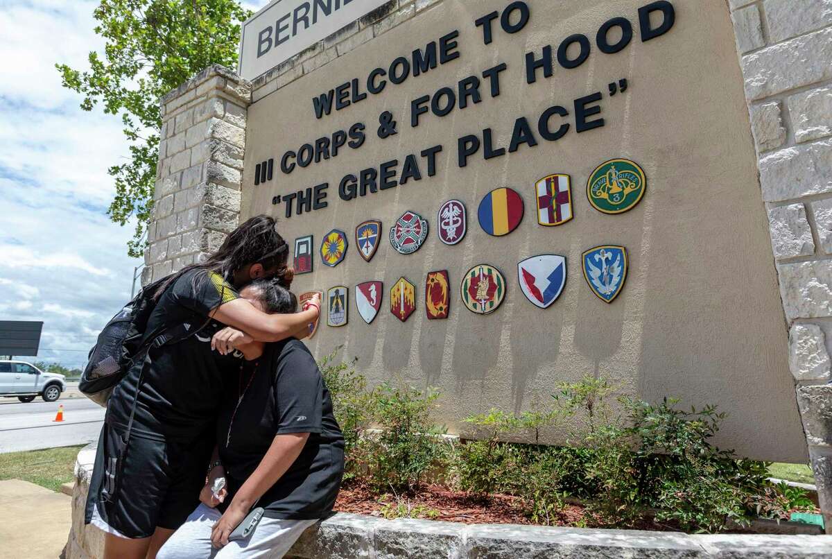 Gloria Guillen, seated, is comforted Tuesday, June 23, 2020 in Killeen by her daughter Lupe Guillen after she spoke at the Fort Hood main gate about her missing daughter, Fort Hood soldier Pfc. Vanessa Guillen.