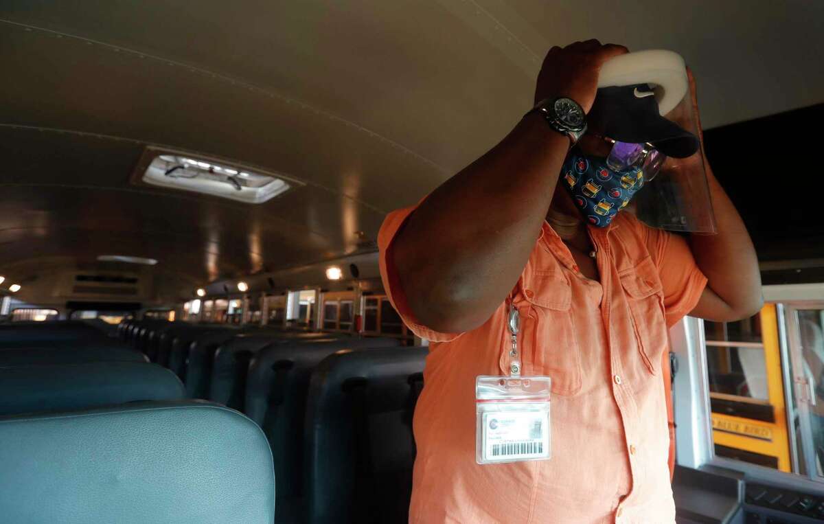 Conroe ISD bus driver Curtiss Chambers adjusts his face shield before heading out at the district’s transportation department, Friday, Sept. 4, 2020, in Conroe.
