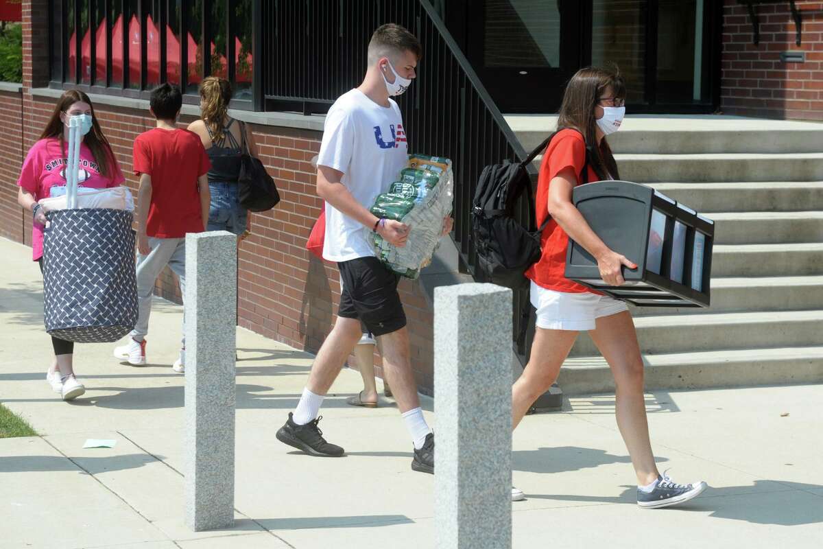 Freshmen arrive on the campus of Sacred Heart University, in Fairfield, Conn. Aug. 25, 2020.