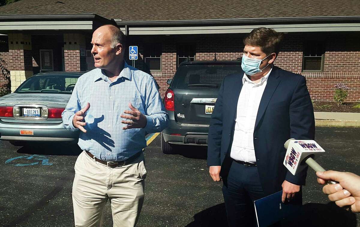 U.S. Rep. John Moolenaar, left, speaks to members of the media after meeting with U.S. Small Business Administration Regional Administrator Rob Scott, right, and other public officials on Thursday at Jerome Township Hall in Sanford. (Dan Chalk/chalk@mdn.net)