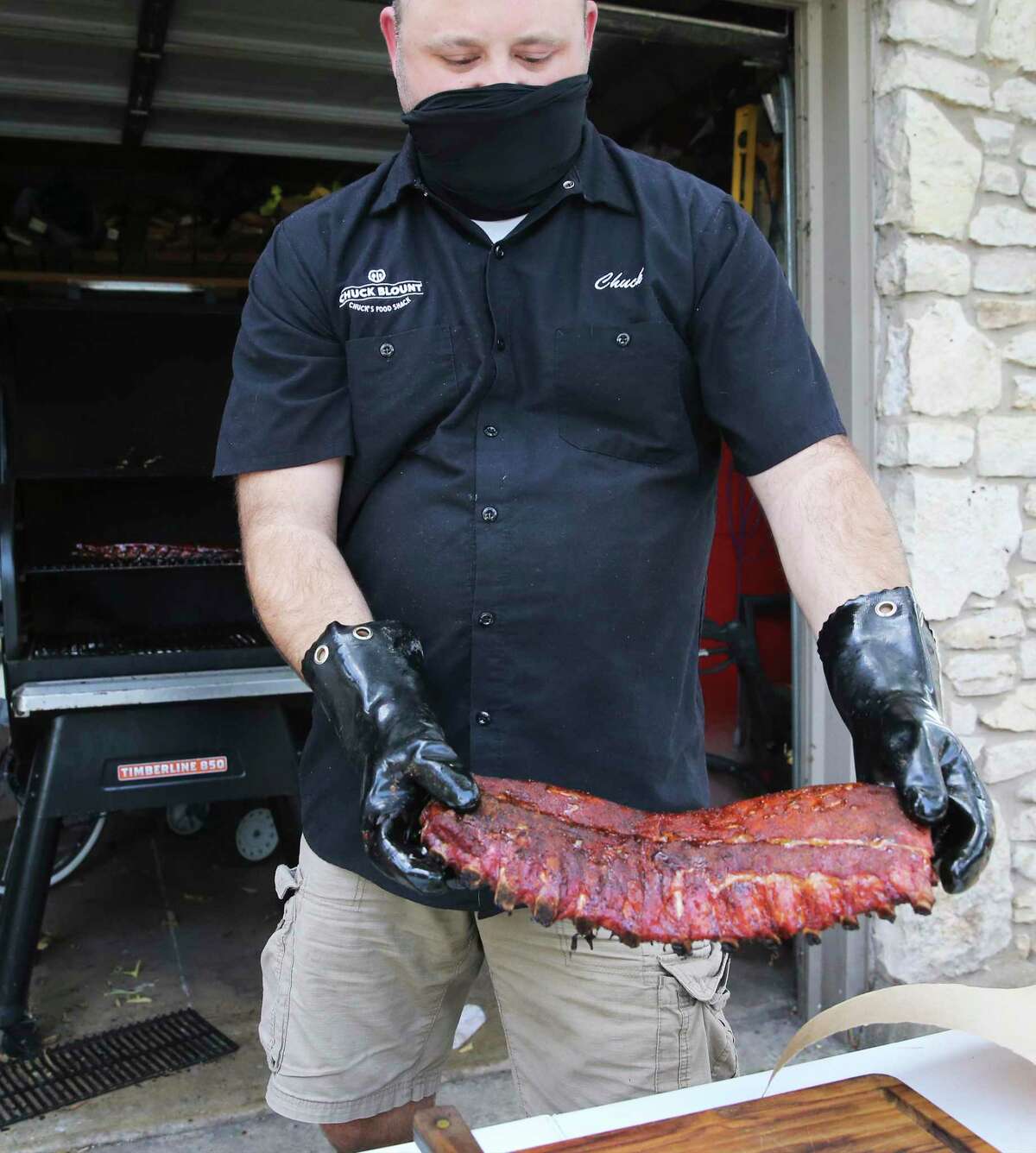Chuck Blount removes baby back ribs from the smoker after a nearly three-hour cooking time.