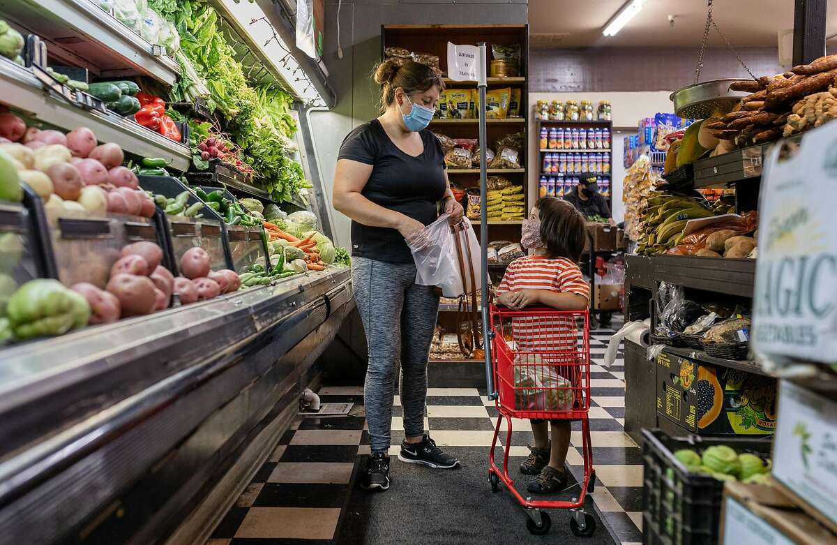 Nilsa Rodas shops with her son, Diego Rodas, at La Plaza Market on Friday, August 21, 2020, in the Canal neighborhood of San Rafael, Calif.