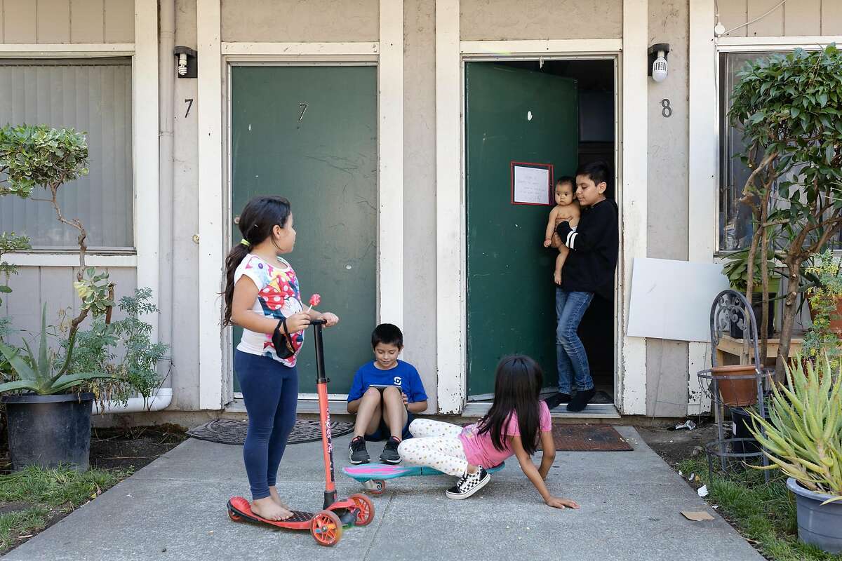 (Left to right) Nicol, Jayner, Jackie, Jailyne and Angel (no last names given) play outside their homes in the Canal neighborhood of San Rafael, Calif., on Friday, August 21, 2020.