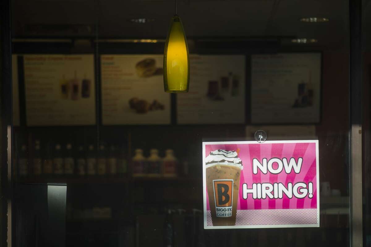 A hiring sign hangs in the window at Biggby Coffee, located at 957 S. Saginaw Rd. in Midland. (Katy Kildee/kkildee@mdn.net)
